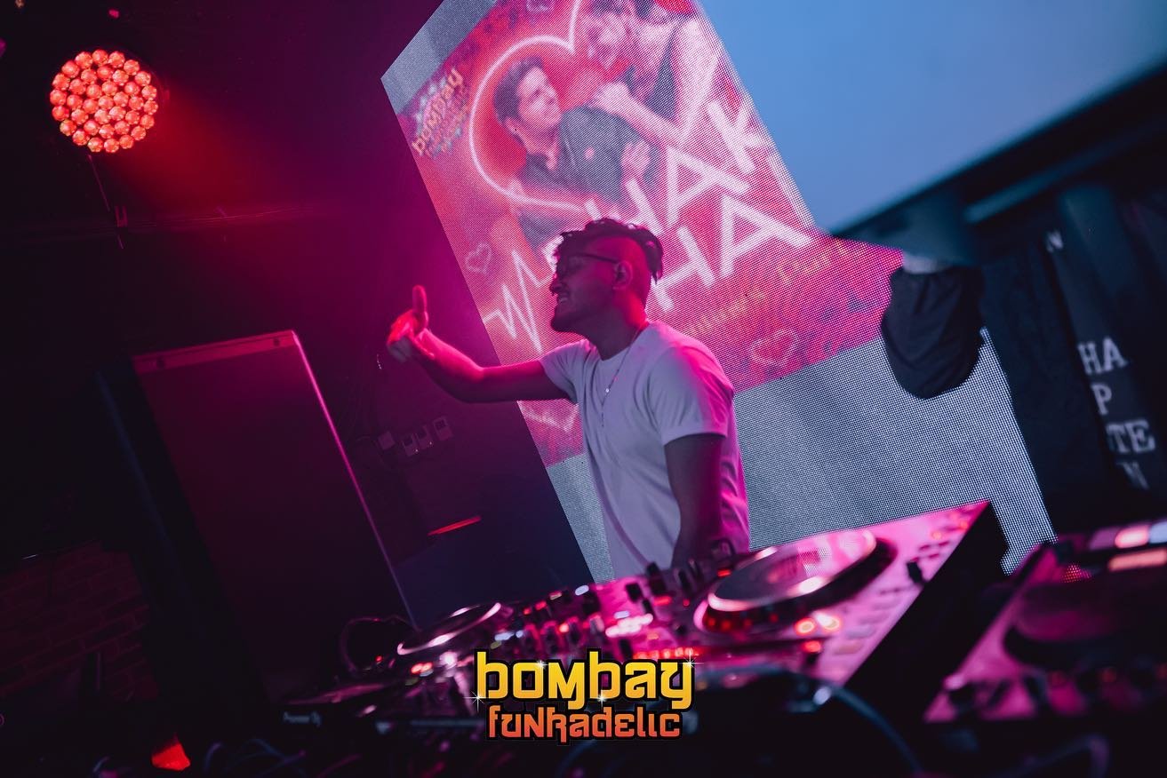 DJ behind the decks at Holi party