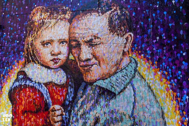 Jimmy C man embracing child mural on Fashion Street, Shoreditch