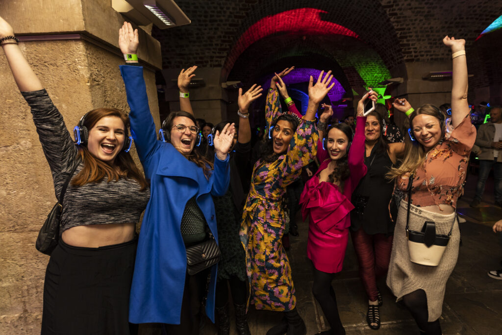 Silent disco attendees dancing in the crypt