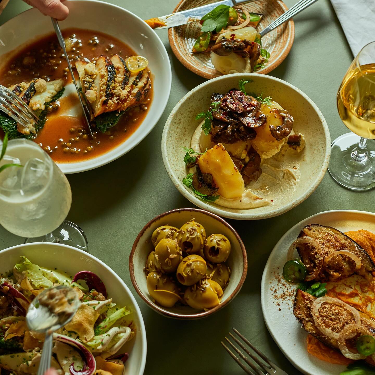 A table full of small sharing plates, and mezze style dishes.