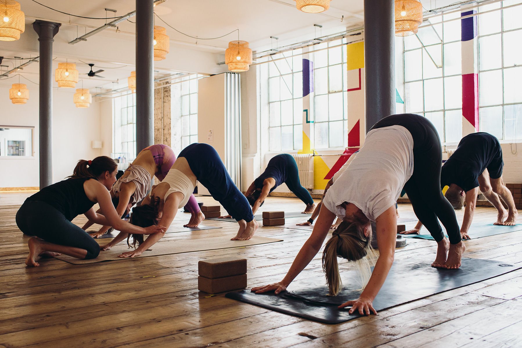 People doing poses in a yoga class at Yogarise Peckham in London