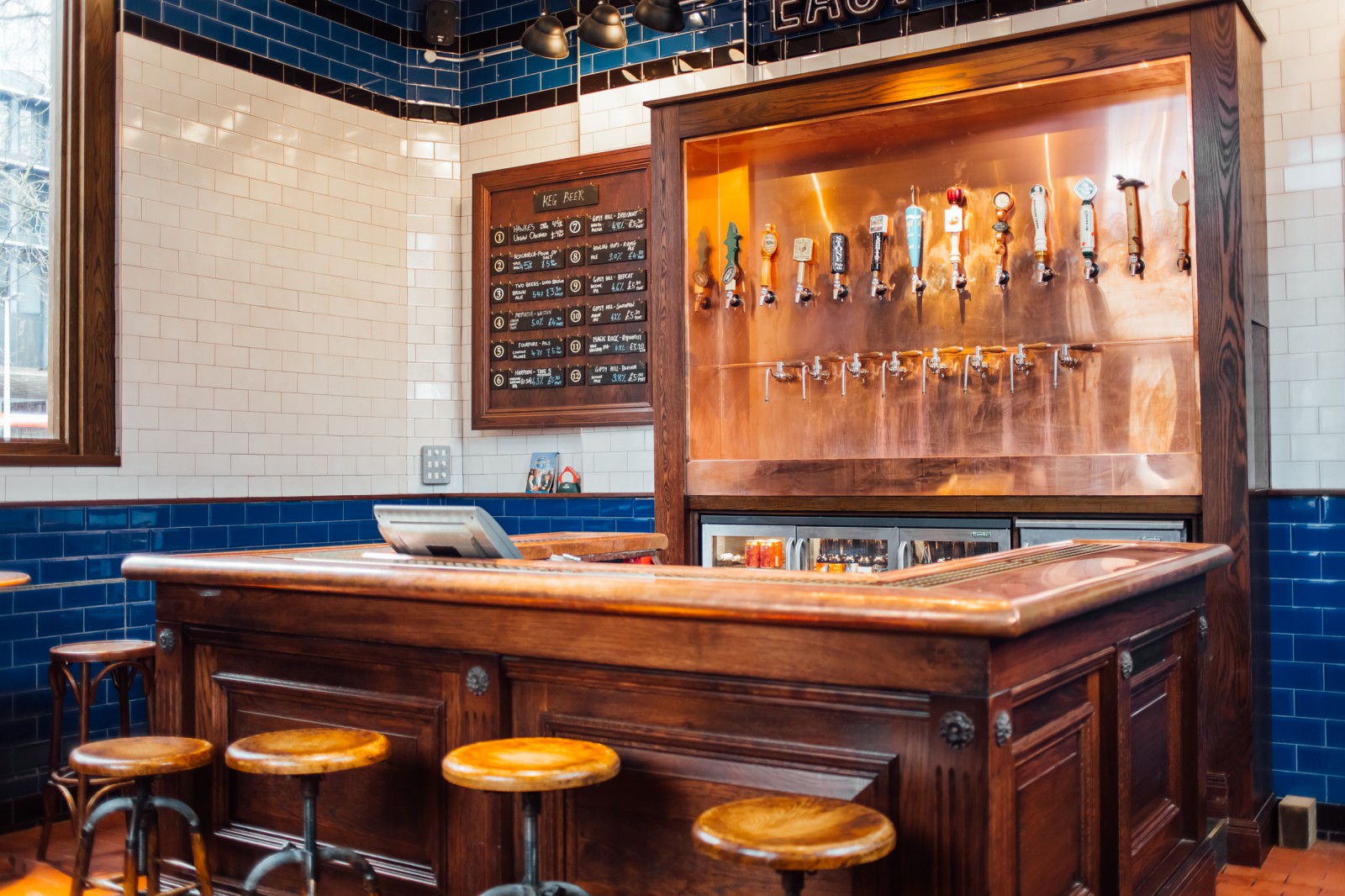 the euston tap interiors with bar stools, chalk board, and pints