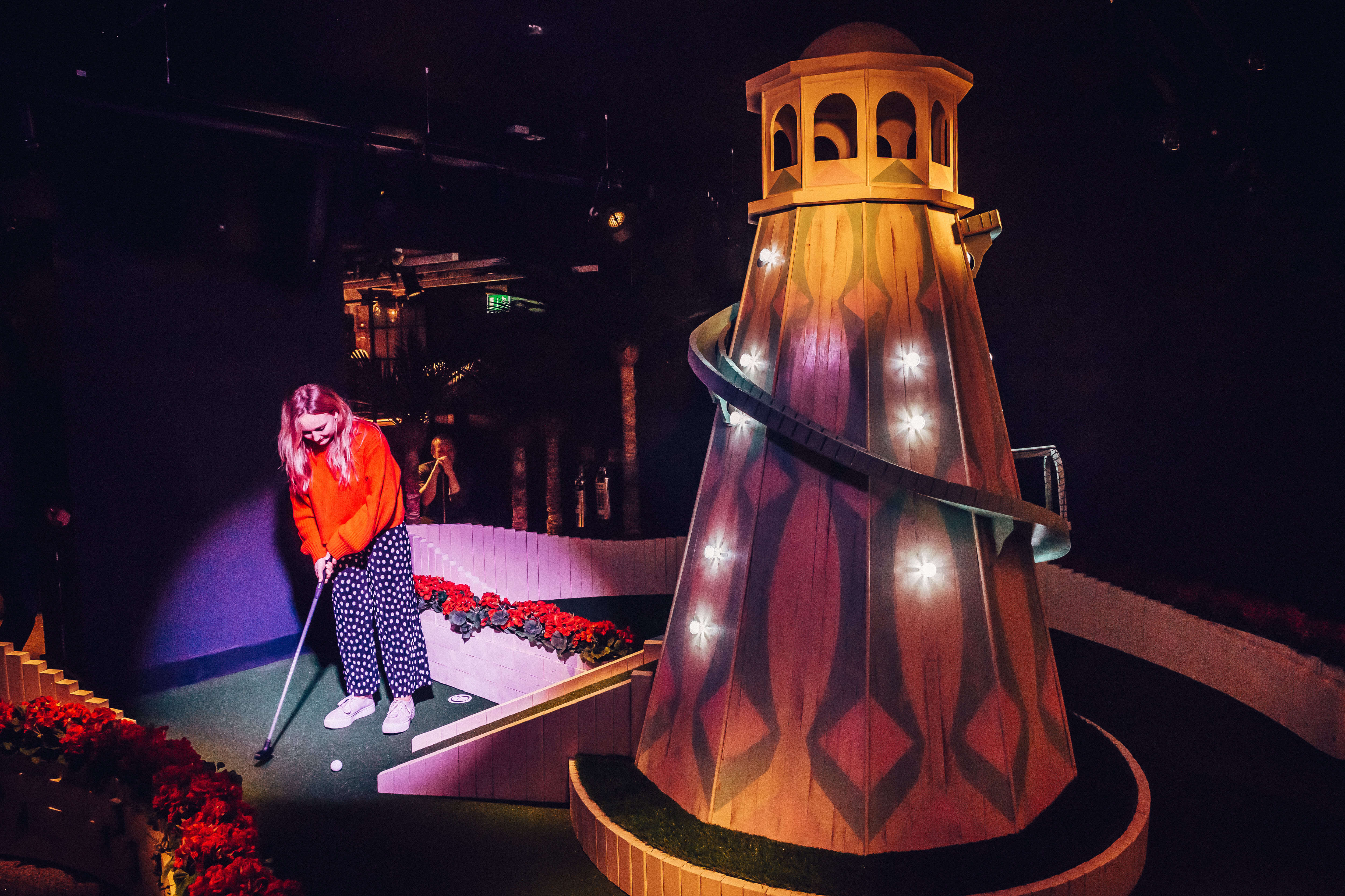 Person playing mini golf at Swingers London, helter skelter